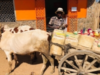 Plusieurs hommes font le travail de l’eau dans la ville d’Ambovombe avec des bidons jaunes ou des barils sur la charrette. 